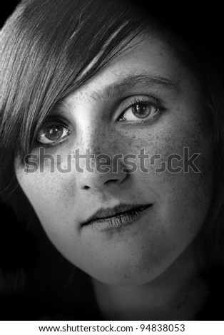 Close portrait of young woman with freckles