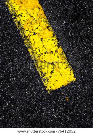 Road with painted yellow line on black asphalt