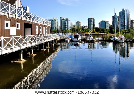 VANCOUVER, CANADA - AUGUST 11, 2011: view of Vancouver downtown and marina from Stanley park in Vancouver, British Columbia, Canada. Vancouver is the most densely populated Canadian municipality.