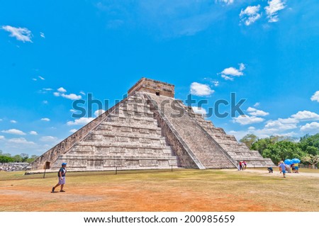 CHICHEN ITZA, MEXICO - APRIL 20, 2014: Tourists visit Chichen Itza, one of the most visited archaeological sites in Yucatan, Mexico. About 1.2 million tourists visit the ruins every year.