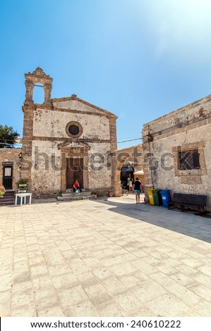 MARZAMEMI, ITALY -  AUGUST 19, 2014: tourists visit main square in Marzamemi, Italy. It is a small village just a few kilometres from Italy\'s southernmost point, in the deep south-east of Sicily.