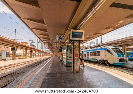 PALERMO, ITALY - AUGUST 21, 2014: passenger on platform and local train at railway station in Palermo, Italy.  The station is owned by the Ferrovie dello Stato, the national rail company of Italy.