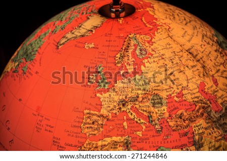 MILAN, ITALY - DECEMBER 17, 2014: red world globe with closeup on Europe and black background in Milan, Italy.  A globe is the only representation of the earth that does not distort its shape or size