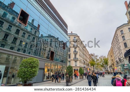 LYON, FRANCE - DECEMBER 7, 2014: downtown street view with locals and tourists in Lyon, France. Lyon is the capital of the Rhone-Alpes region and France\'s third largest city after Paris and Marseille.