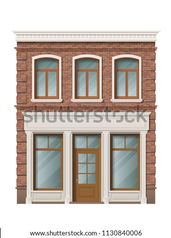 Old brick building facade with windows and shop on ground floor. Traditional classic architecture of front building. Storefront with large windows on the ground floor.