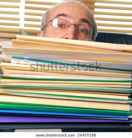 Man with a work overload in front of him