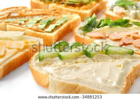 Several pieces of toast with various toppings on each