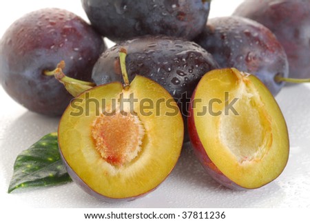 Extreme close-up background image of plums with leaf