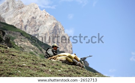 Soldier with machine gun is on sentry duty in the Himalayas
