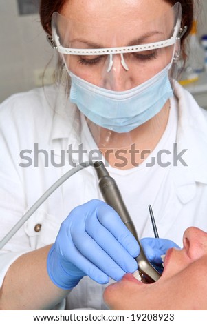 Female Dentist Is Drilling The Patients Tooth Stock Photo 19208923 ...