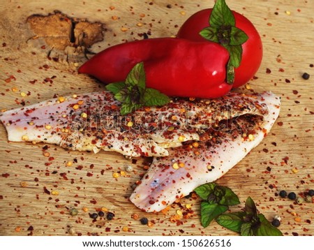 smoked fish with pepper and chili on a bed of oak