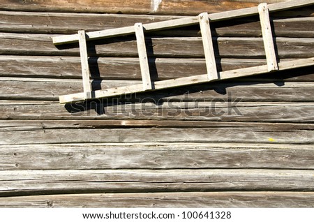 background of old retro log house wall and wooden ladder hanging.