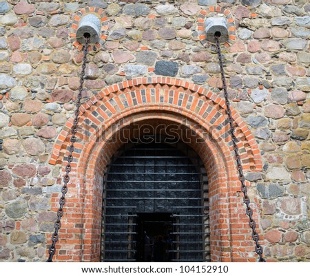 Entrance to hall of castle gates hang on chains. Trakai castle details XIV, XV century architecture.