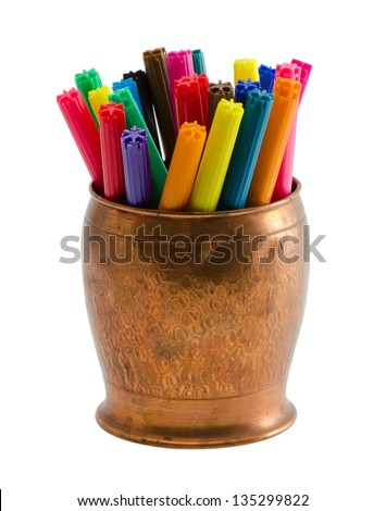 closeup of motley colorful felt-tip felt tip pens in copper bowl isolated on white background