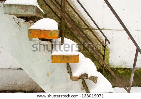 powdery snow cover the old cement stairs.