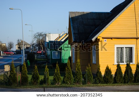 country wooden painted house along the street