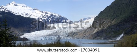 Panoramic view of Mendenhall Glacier that melts down rapidly, not long ago it\'s ice were reaching the waterfall (Juneau, Alaska).