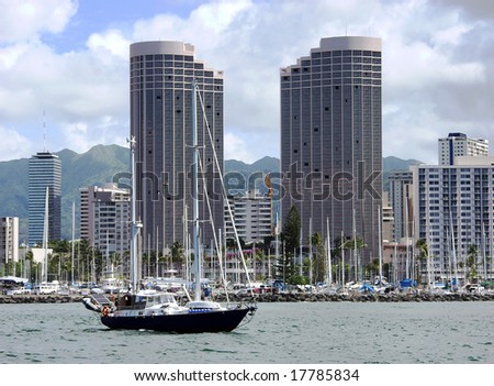 The yacht is leaving Honolulu downtown harbor (Hawaii).