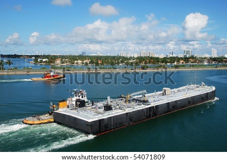 Tug boats helping the platform to navigate in Miami port (Florida).