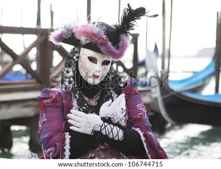 VENICE, ITALY - FEB 18: Unidentified person in Venetian mask at St. Marco Square, Carnival of Venice on February 18, 2011.