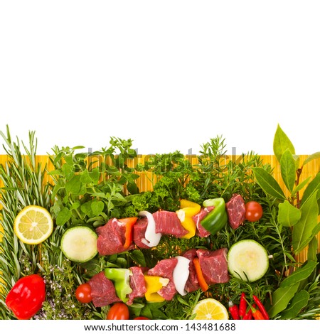 slices of fresh meat with vegetables and herbs on a yellow wicker mat isolated on white background