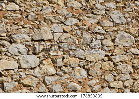 Background of stone wall texture  - stone wall of stones of various shapes photo