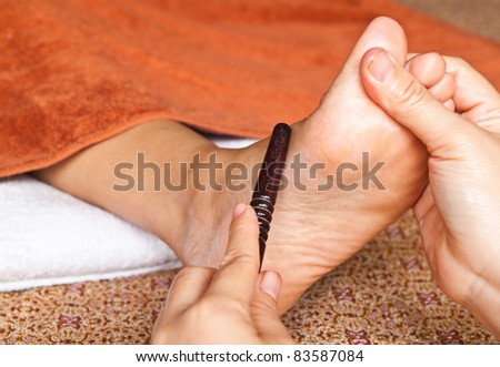 reflexology foot massage by stick wood, spa foot treatment,Thailand