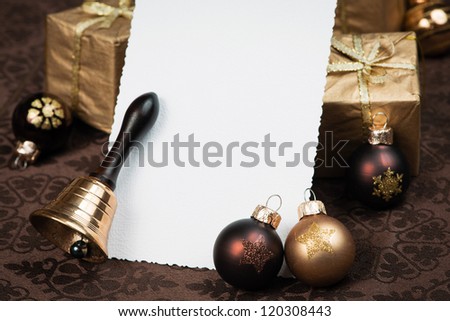 Christmas greeting card with brown Christmas balls, presents and bell