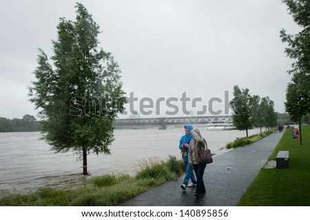 BRATISLAVA, SLOVAKIA - JUNE 3: Pedestrians observe the situation on the Danube river close to Bratislava Shopping center on June 3, 2013