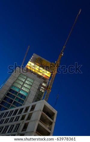 night shot of construction building site with tower crane loader