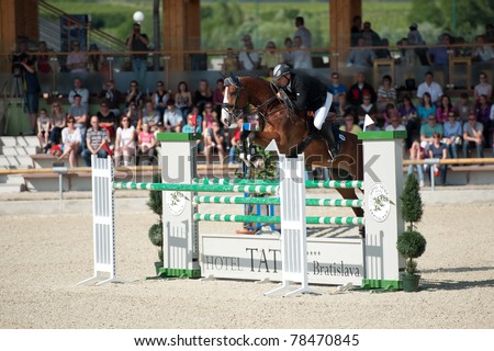 PEZINOK, SLOVAKIA - MAY 29: Marian Stangel (CZE) on horse Denver 2 jumps over a hurdle at Sheron Grand Prix CSI1* on May 29, 2011 in Pezinok, Slovakia