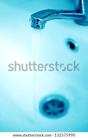 Water tap. Macro image in blue tone.