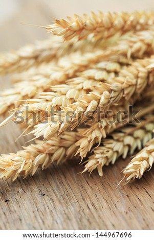 Ears of wheat on a wooden table
