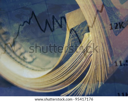 Market graph and rolled dollars. Finance concept.