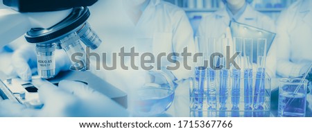 Panoramic web banner of microscope in a medical research lab or science laboratory, study for making vaccine to protection a coronavirus COVID-19