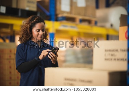 warehouse worker using bar code scanner to analyze newly arrived goods for further placement in storage department, logistic working at warehouse.