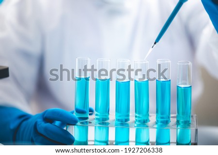 Researchers scientist working analysis with blue liquid test tube in the laboratory, chemistry science or medical biology experiment technology, pharmacy development solution Stockfoto © 