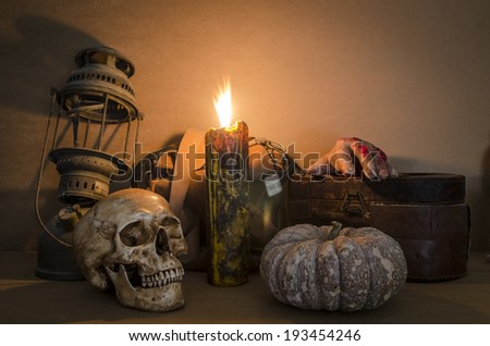 Still life with skull, old lamp, pumpkin and candle