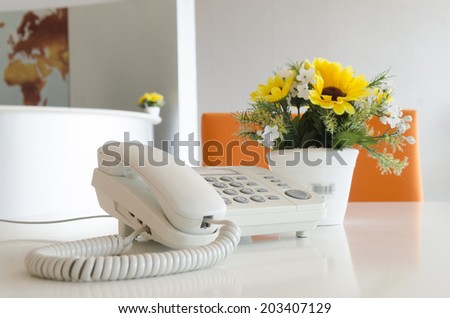 Close up view of a work desk interior with telephone