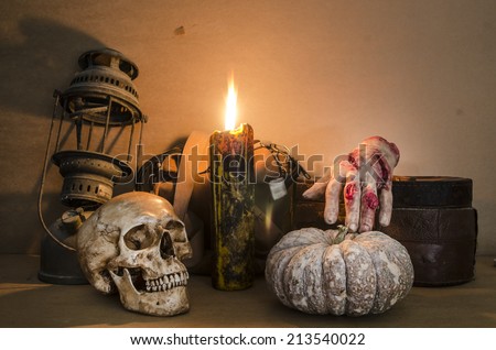 Halloween image with a burning candle on an ancient skull