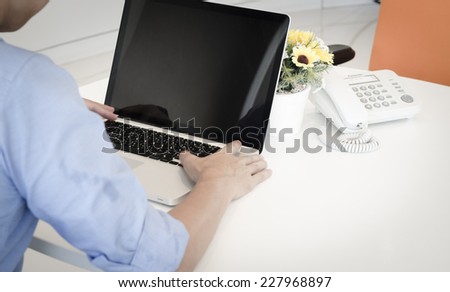 Hands of a man working with laptop