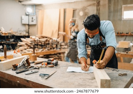 Similar – Image, Stock Photo Professional carpenter at work, he is carving wood using a woodworking tool, hands close up, carpentry and craftsmanship concept