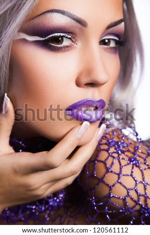 portrait of sexy young woman with cold violet makeup
