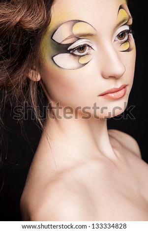portrait of young sexy woman with creative makeup, face art