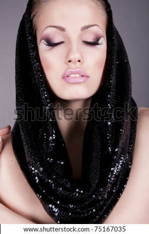 pretty brunette woman in  black hood with creative makeup