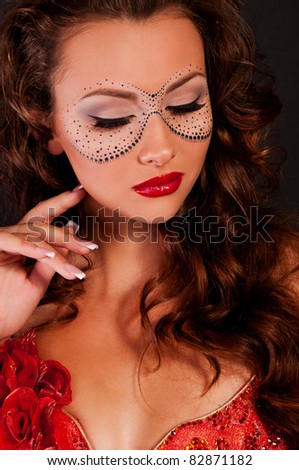 wonderful woman with mask on face in red dress with red sexy lips