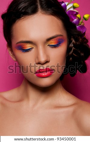 sexy brunette woman with bright make up on pink background