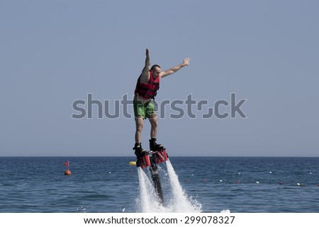 CAMYUVA, KEMER, TURKEY - JULY 16, 2015: Unidentified Turkish man studying extreme flyboard. Extreme water sports are increasingly popular on the beaches of Turkey