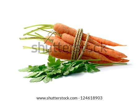 Studio macro of organic vegetables, carrots and flat leaf parsley, on a white background. Copy space.