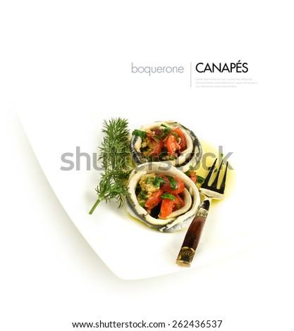 Overhead shot of fresh boquerone canapes with garlic, tomato, parsley and extra virgin olive oil. Styled in white with generous copy space. The perfect image for your seafood menu cover design.